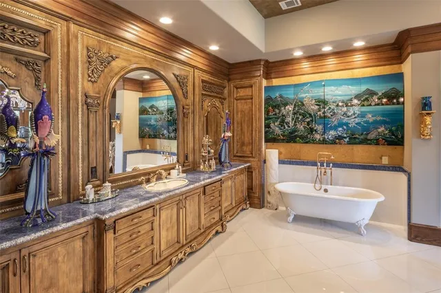 a bathroom with a double vanity sink a mirror and a bathtub