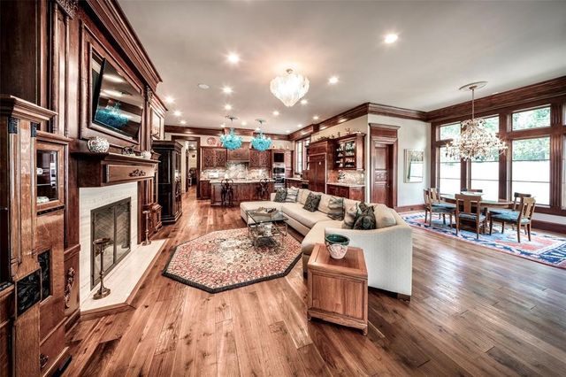 a living room with fireplace furniture and a wooden floor