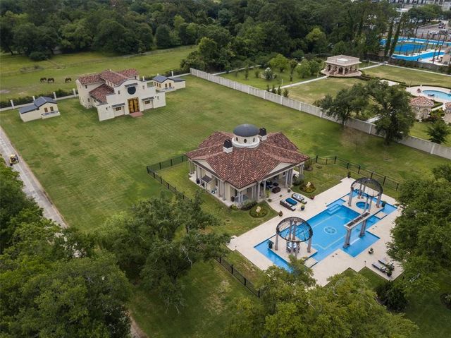 an aerial view of a house with garden space and lake view