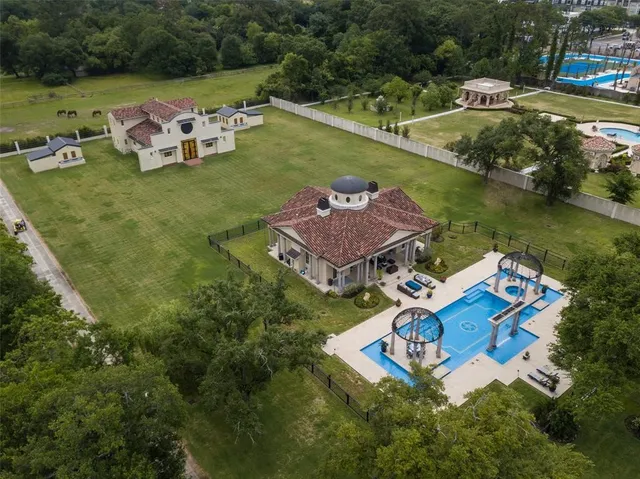 an aerial view of a house with garden space and lake view