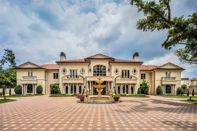 a view of a white house with a bench in front of it