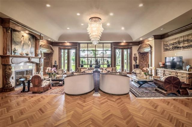 a living room with furniture a large window and kitchen view