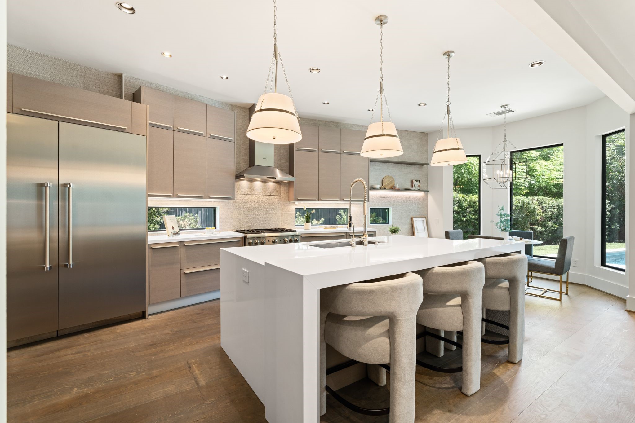 3703 Wroxton Road West University Place, TX 77005 - Photo 9 of 36 Designed for both entertaining and everyday living, the gourmet kitchen offers an expansive island, professional-grade appliances, sleek custom cabinetry, and sunlit breakfast area overlooking the pool.