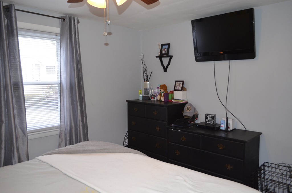 51 Cheyenne Road Springfield, MA 01109 - Photo 17 of 28 a bedroom with a bed and flat screen tv