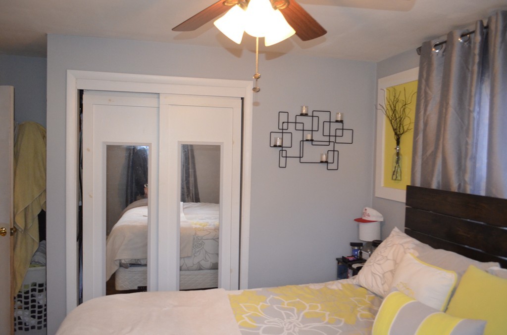 51 Cheyenne Road Springfield, MA 01109 - Photo 18 of 28 a bedroom with a bed and a chandelier