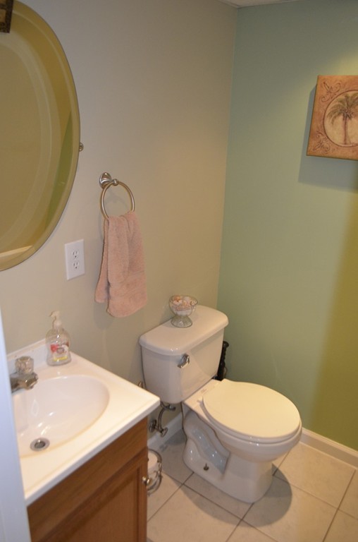 51 Cheyenne Road Springfield, MA 01109 - Photo 23 of 28 a bathroom with a sink mirror vanity and toilet