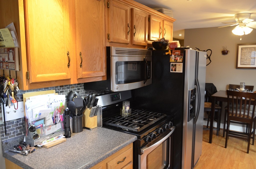 51 Cheyenne Road Springfield, MA 01109 - Photo 25 of 28 a kitchen with granite countertop a stove and a wooden floor