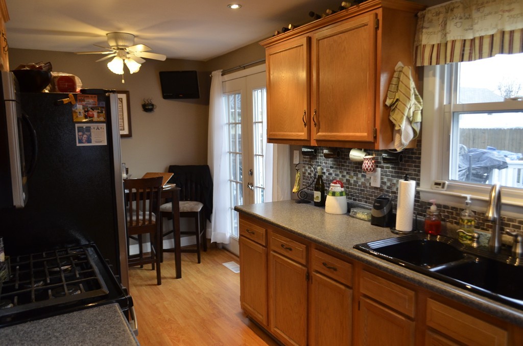 51 Cheyenne Road Springfield, MA 01109 - Photo 3 of 28 a kitchen with kitchen island granite countertop a sink stove and cabinets
