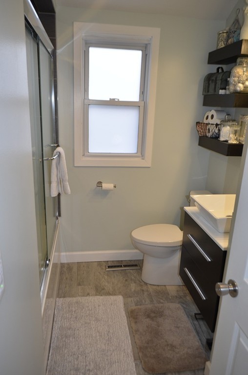 51 Cheyenne Road Springfield, MA 01109 - Photo 8 of 28 a bathroom with a toilet a sink and a mirror