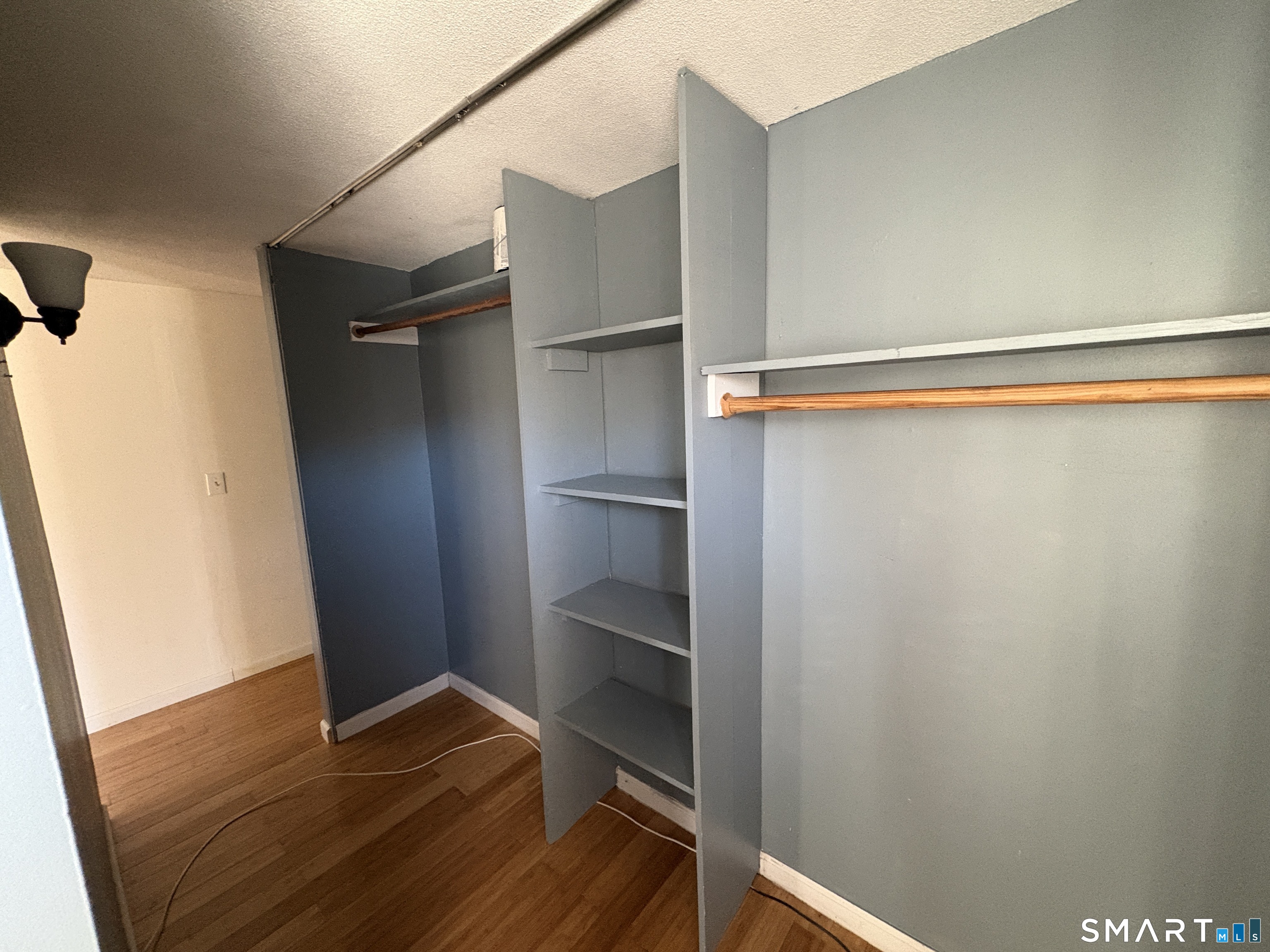13 Lakeside Drive, Unit M Ledyard, CT 06339 - Photo 13 of 16 a view of walk in closet with empty racks