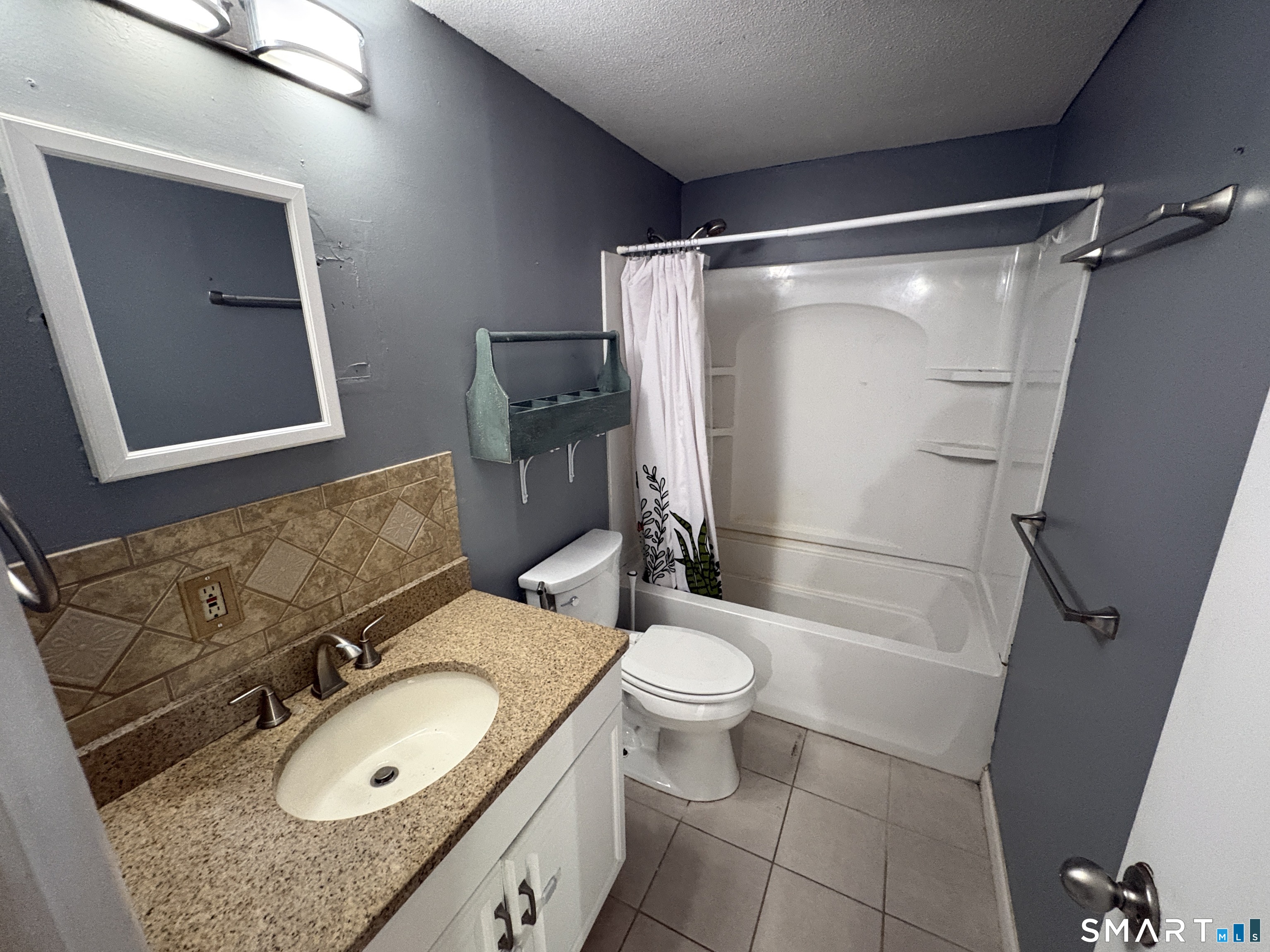 13 Lakeside Drive, Unit M Ledyard, CT 06339 - Photo 14 of 16 a bathroom with a sink toilet and shower