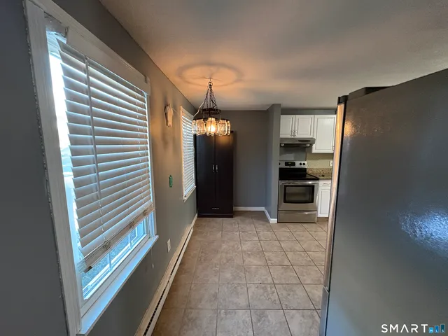 a view of a kitchen with a sink and a refrigerator