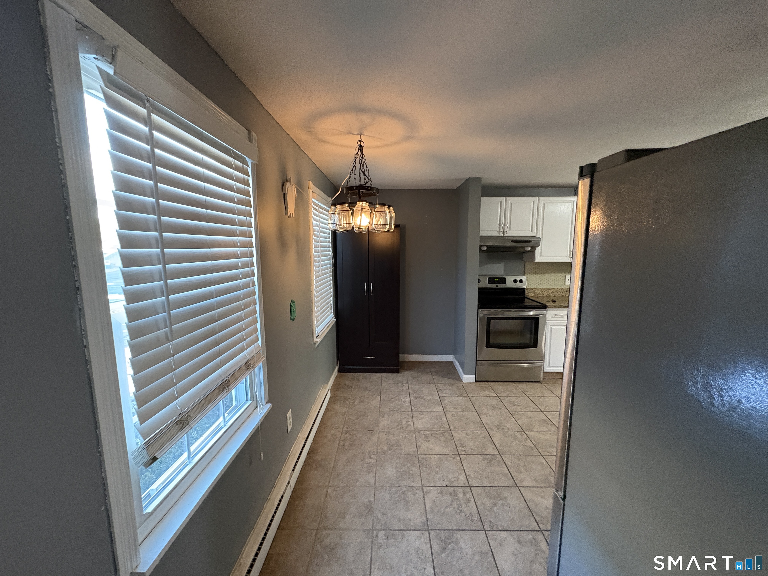 13 Lakeside Drive, Unit M Ledyard, CT 06339 - Photo 4 of 16 a view of a kitchen with a sink and a refrigerator