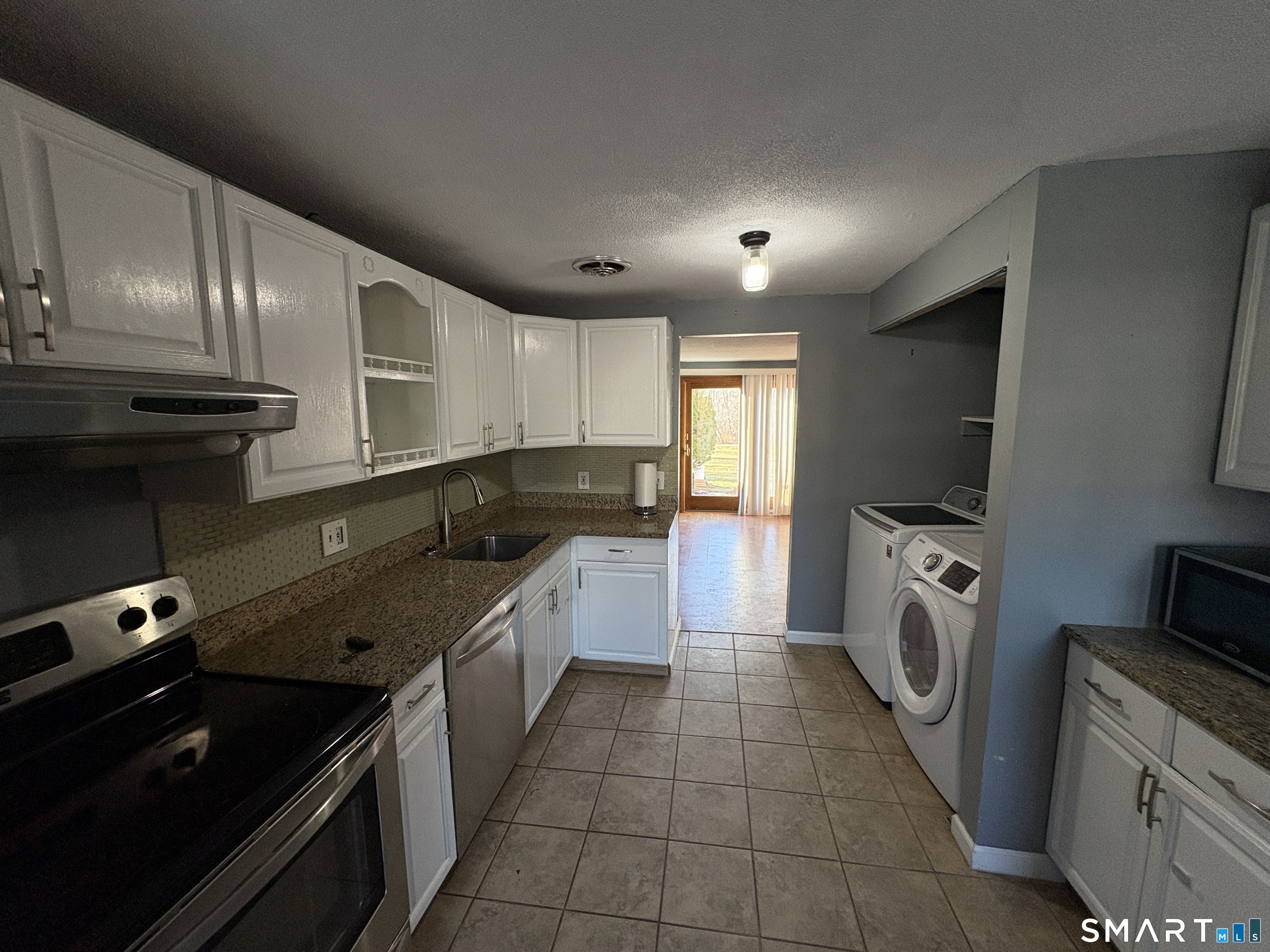 13 Lakeside Drive, Unit M Ledyard, CT 06339 - Photo 7 of 16 a kitchen with a sink a stove and cabinets