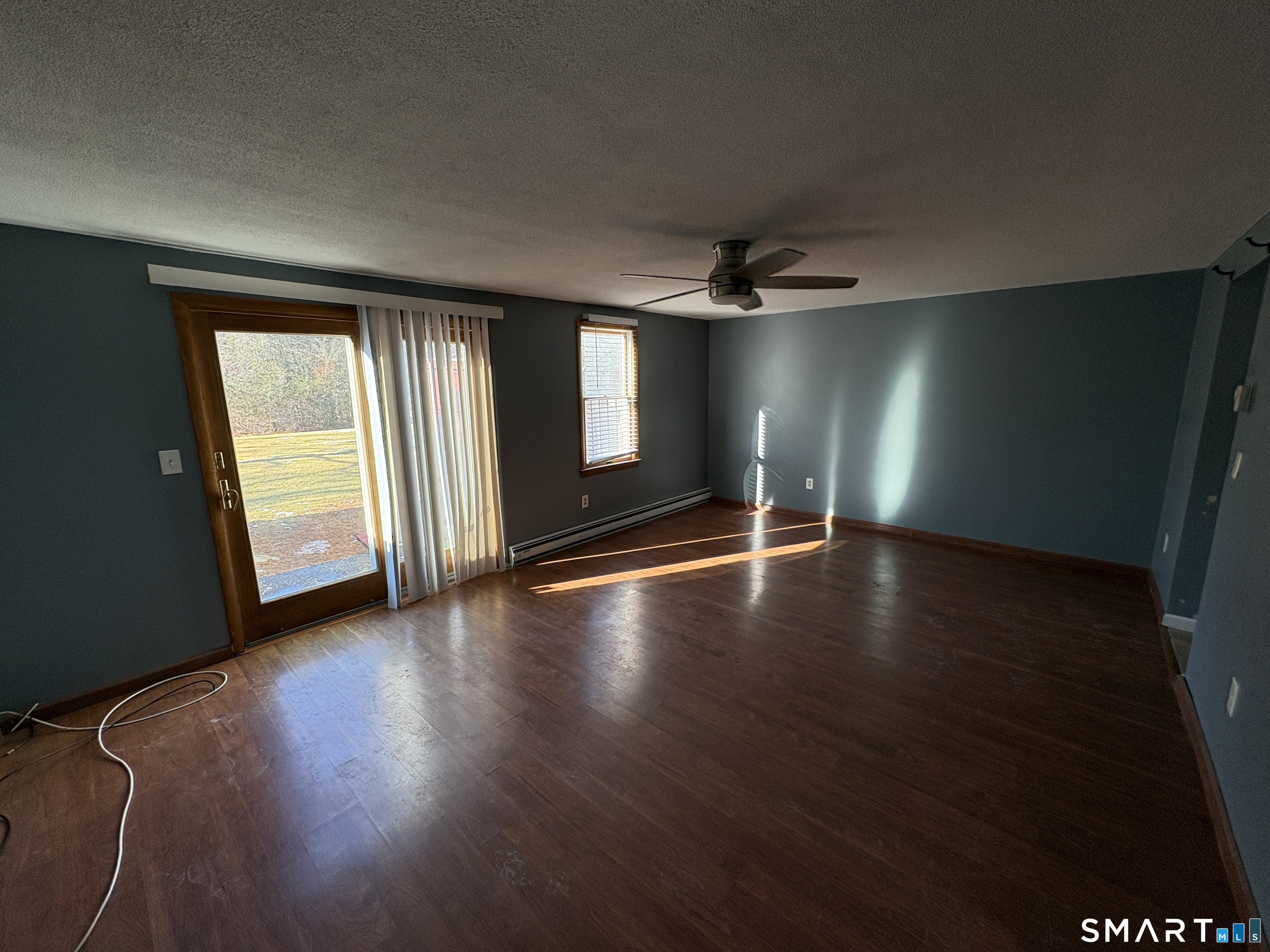 13 Lakeside Drive, Unit M Ledyard, CT 06339 - Photo 8 of 16 a view of an empty room with wooden floor and a window