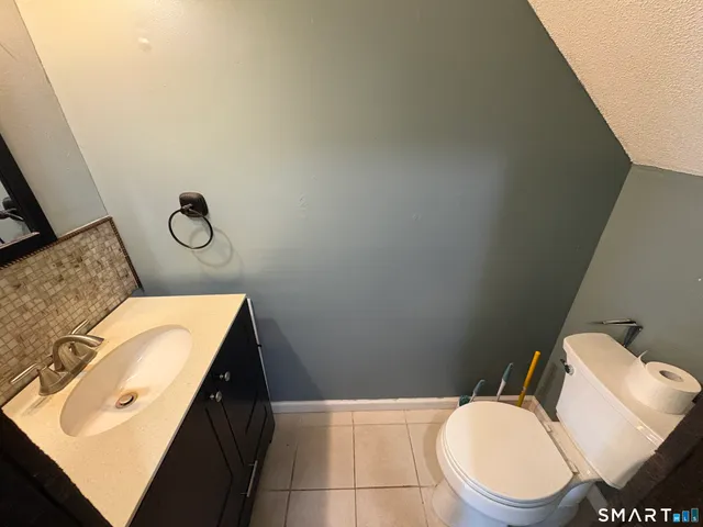 a bathroom with a sink toilet and mirror