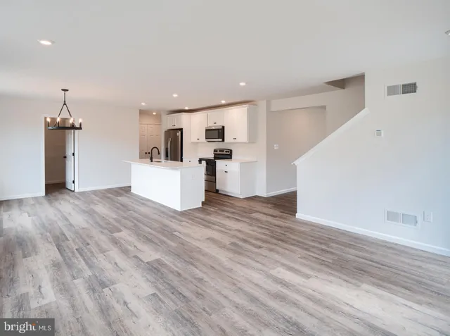 a view of a kitchen with a sink and a refrigerator