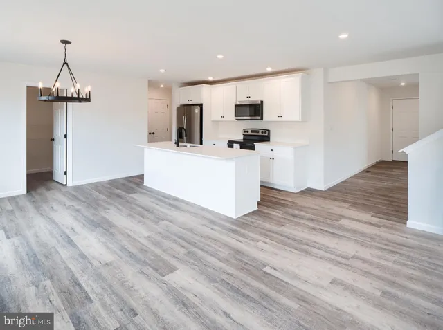 a view of kitchen with microwave and refrigerator