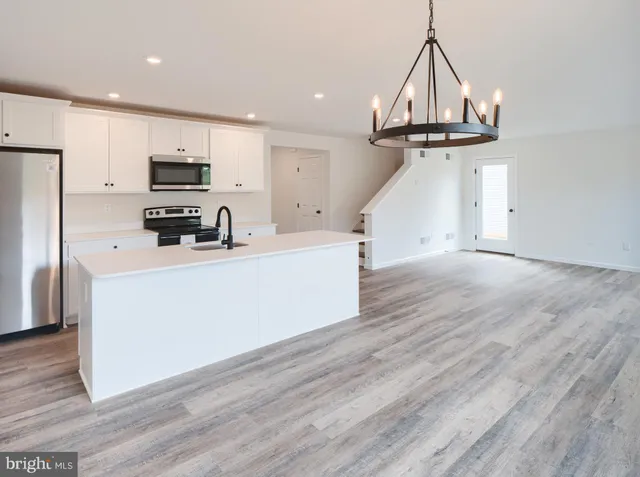 a view of a kitchen with microwave and cabinets