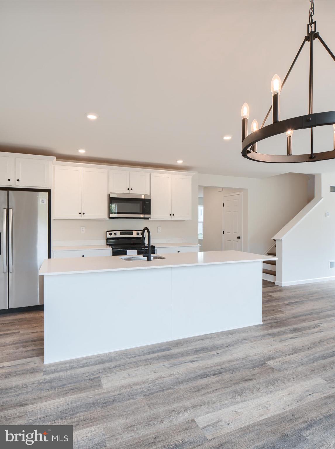 311 Boxwood Drive Windsor, PA 17366 - Photo 17 of 50 a kitchen with stainless steel appliances granite countertop a stove a refrigerator a sink and dishwasher with wooden floor