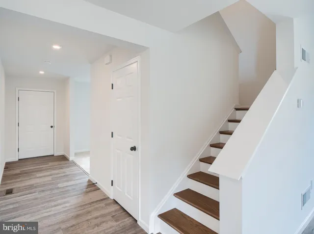a view of an entryway with wooden floor