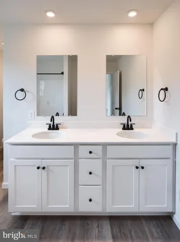 a bathroom with a sink vanity and mirror