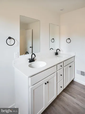 a bathroom with a double vanity sink and a mirror