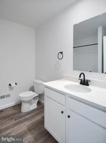 a bathroom with a sink a toilet and mirror