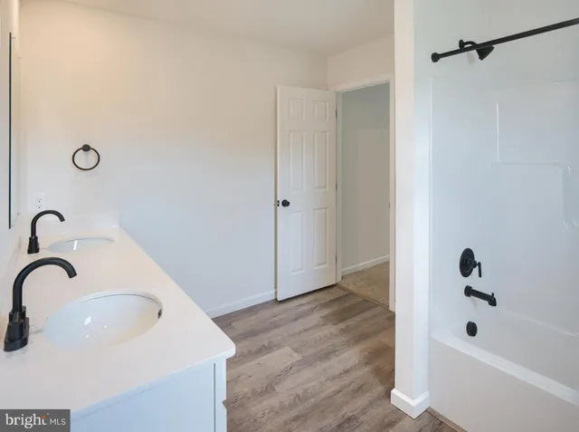 a bathroom with a sink a mirror and a bathtub