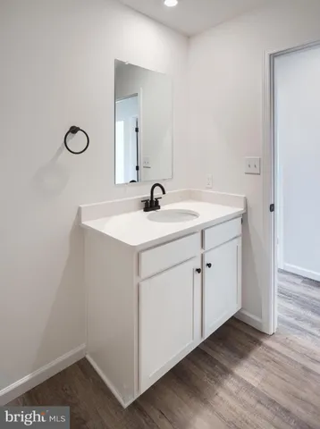 a bathroom with a sink vanity and a mirror