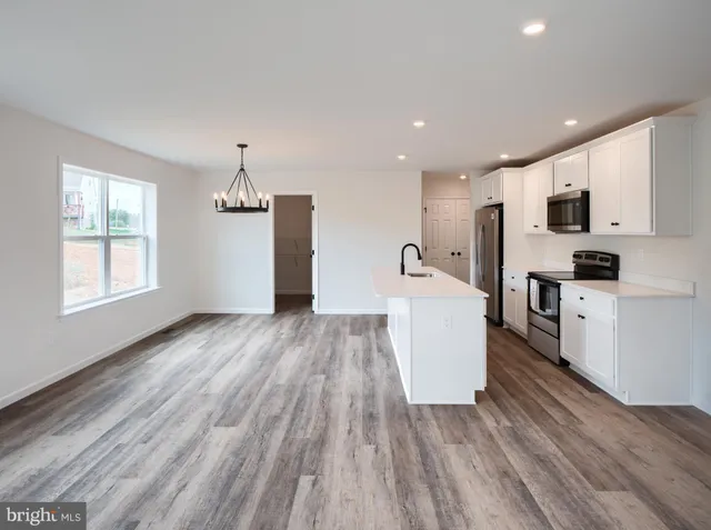 a view of kitchen with sink microwave refrigerator and stove
