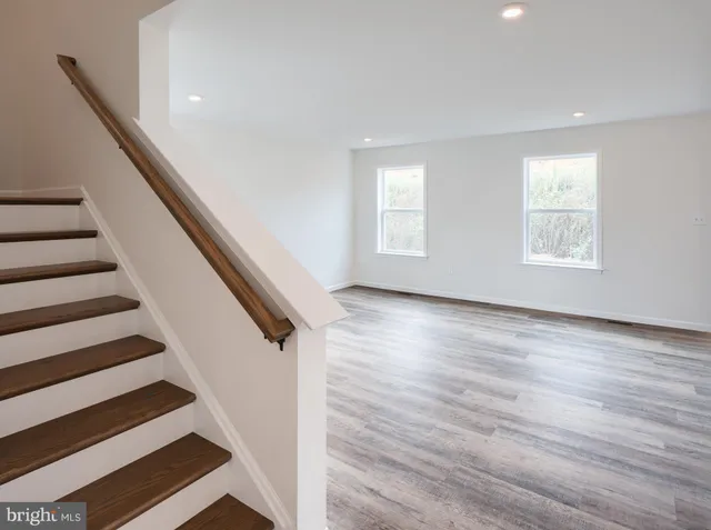 a view of entryway with wooden floor and stairs