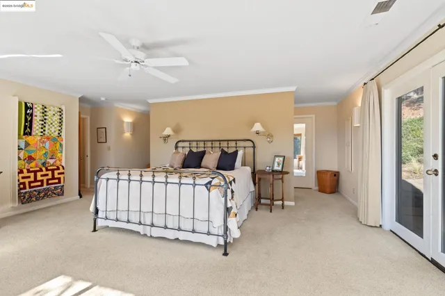 a bedroom with bed and a chandelier