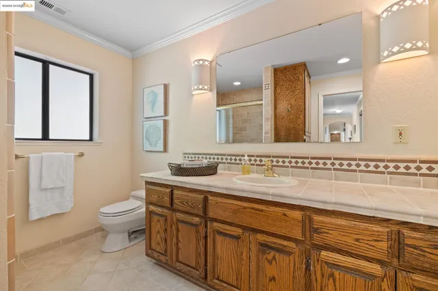 a room with furniture pool table and window