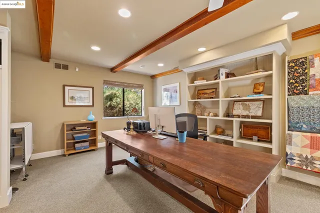 a room with a door open and a mirror