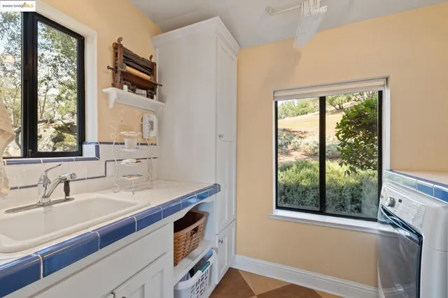 a view of a house with wooden deck front of house