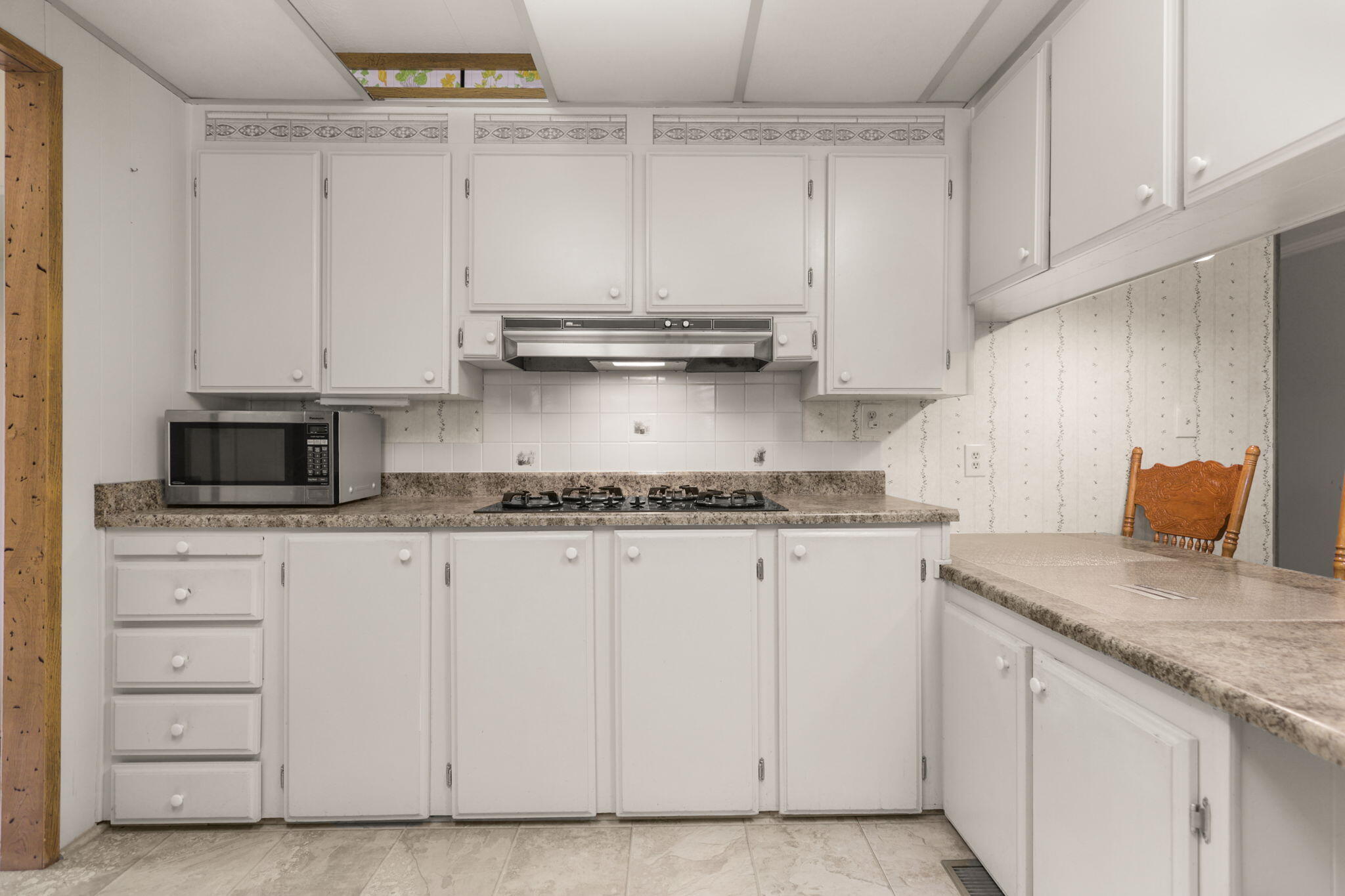 836 August Way Redding, CA 96003 - Photo 11 of 32 a kitchen with granite countertop white cabinets and a stainless steel appliances