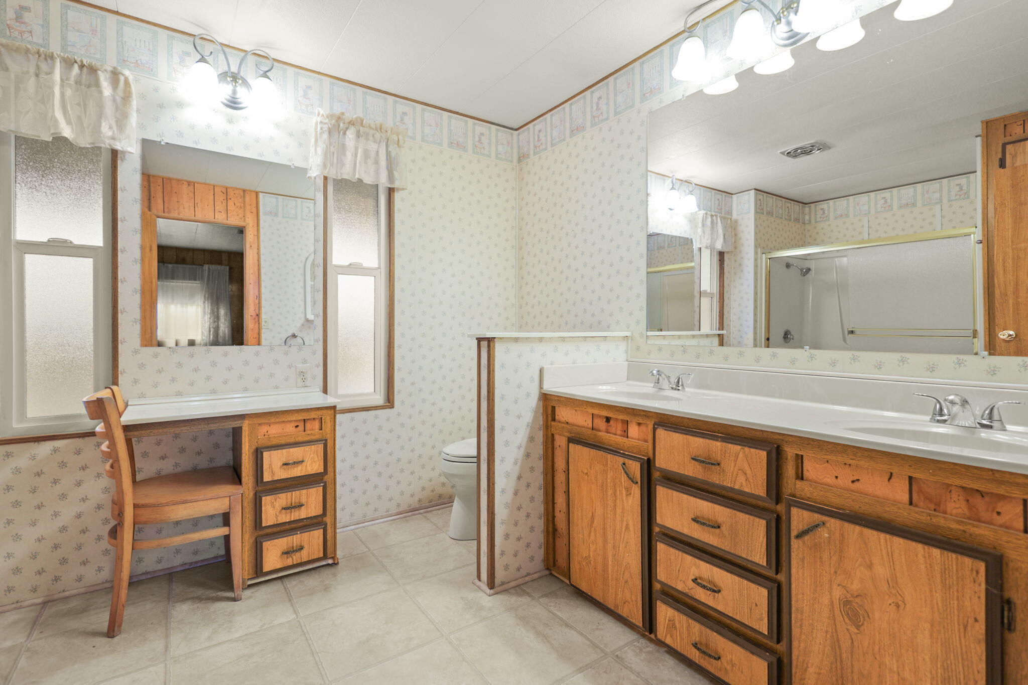 836 August Way Redding, CA 96003 - Photo 16 of 32 a spacious bathroom with a double vanity sink and a mirror