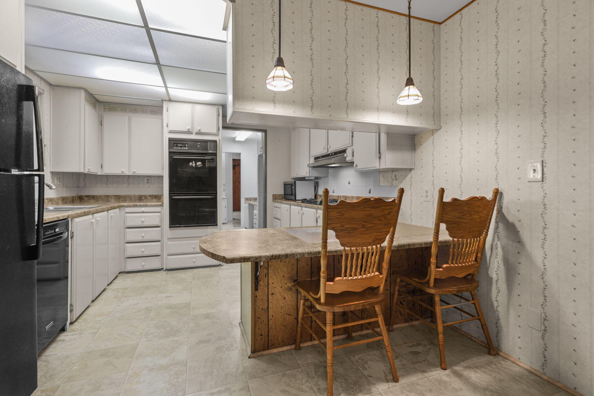 836 August Way Redding, CA 96003 - Photo 10 of 32 a kitchen with stainless steel appliances kitchen island granite countertop a table and chairs in it