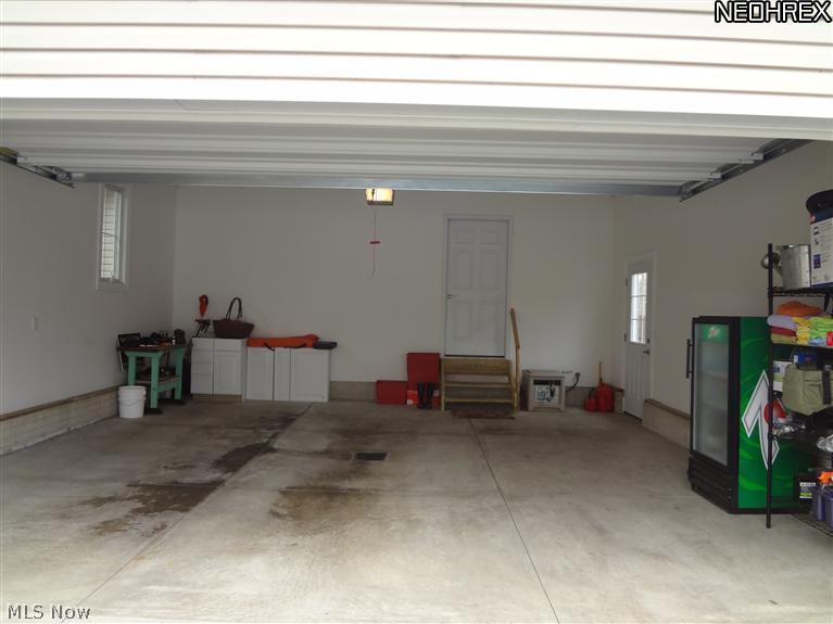 17386 Barnstable Road Middlefield, OH 44062 - Photo 21 of 23 Inside of garage with man door to inside and also one to the backyard.