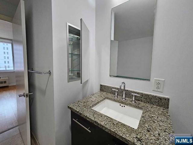 807 Hudson Park Edgewater, NJ 07020 - Photo 10 of 27 a bathroom with a granite countertop sink and a mirror