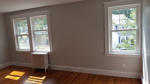 14 Governors Road Milton, MA 02186 - Photo 11 of 19 a view of empty room with wooden floor and windows