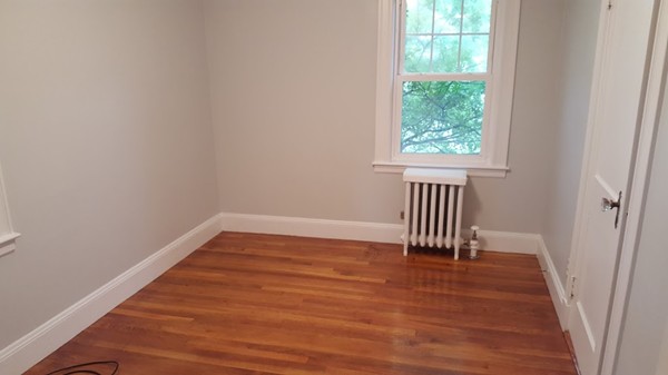 14 Governors Road Milton, MA 02186 - Photo 15 of 19 a view of empty room with wooden floor and fan