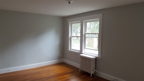 14 Governors Road Milton, MA 02186 - Photo 18 of 19 a view of an empty room with wooden floor and a window