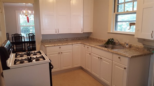 14 Governors Road Milton, MA 02186 - Photo 8 of 19 a kitchen with a sink stove and cabinets
