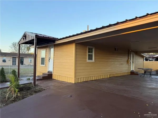 a backyard of a house with shaded area