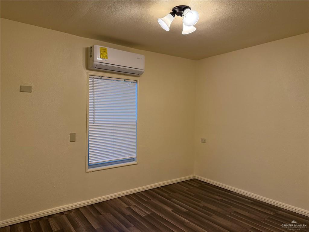 302 Madrigal Street Roma, TX 78584 - Photo 7 of 9 a view of an empty room with wooden floor and a window