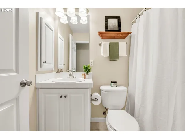 a bathroom with a sink a toilet and mirror