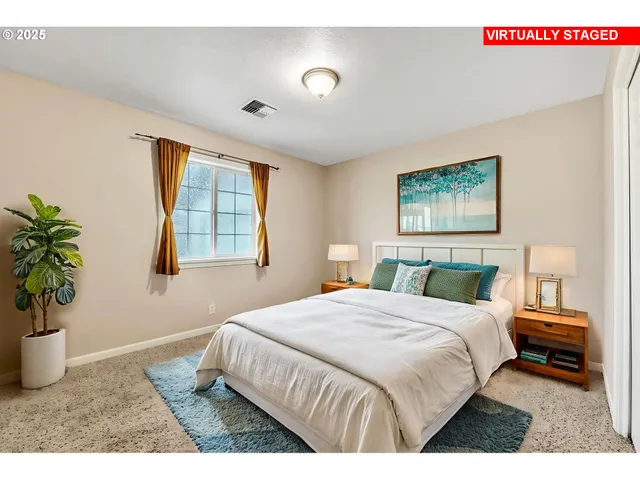 a bedroom with a bed and a potted plant