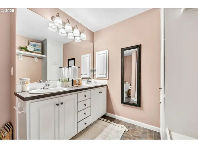 a bathroom with a double vanity sink and a mirror